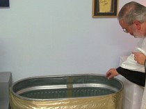 Blessing the baptismal water.